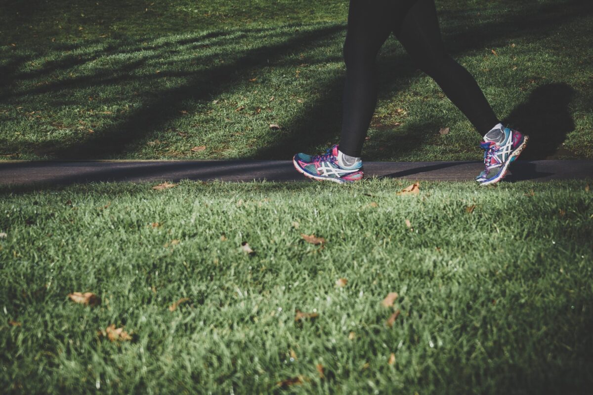 Legs of woman walking in park