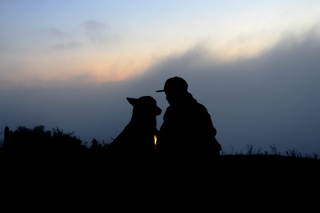 Person and dog sitting down outside